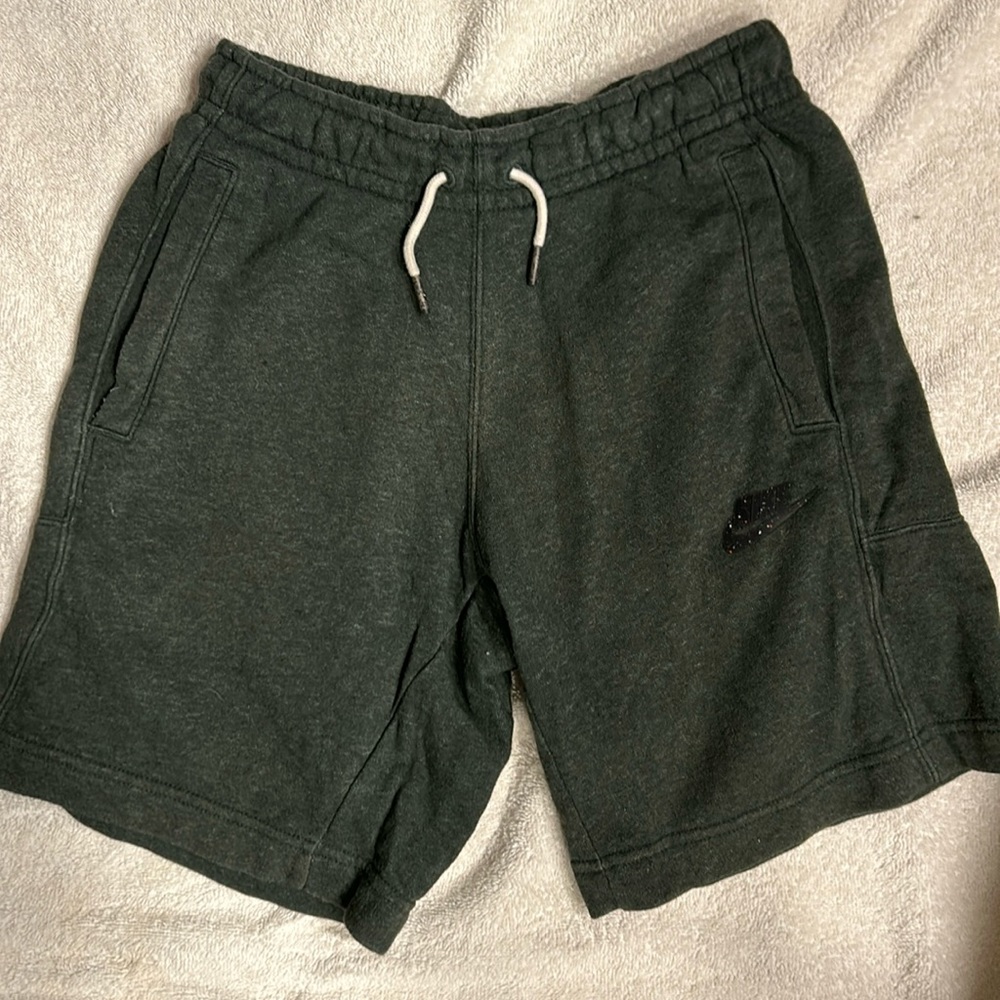 2 pair of Nike shorts.  Youth Large. 1 black and 1 dark green.